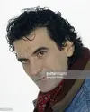 portrait-of-italian-actor-and-director-massimo-troisi-wearing-a-scarf-picture-id471327032.jpg